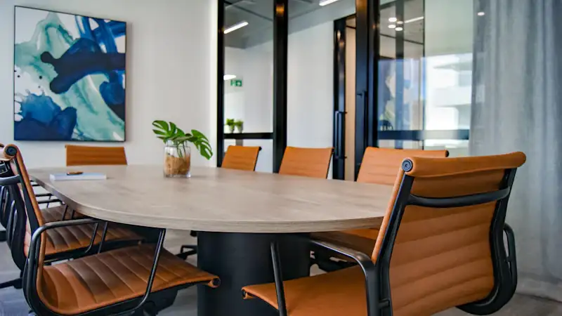 Executive boardroom with a long wooden table and chairs
