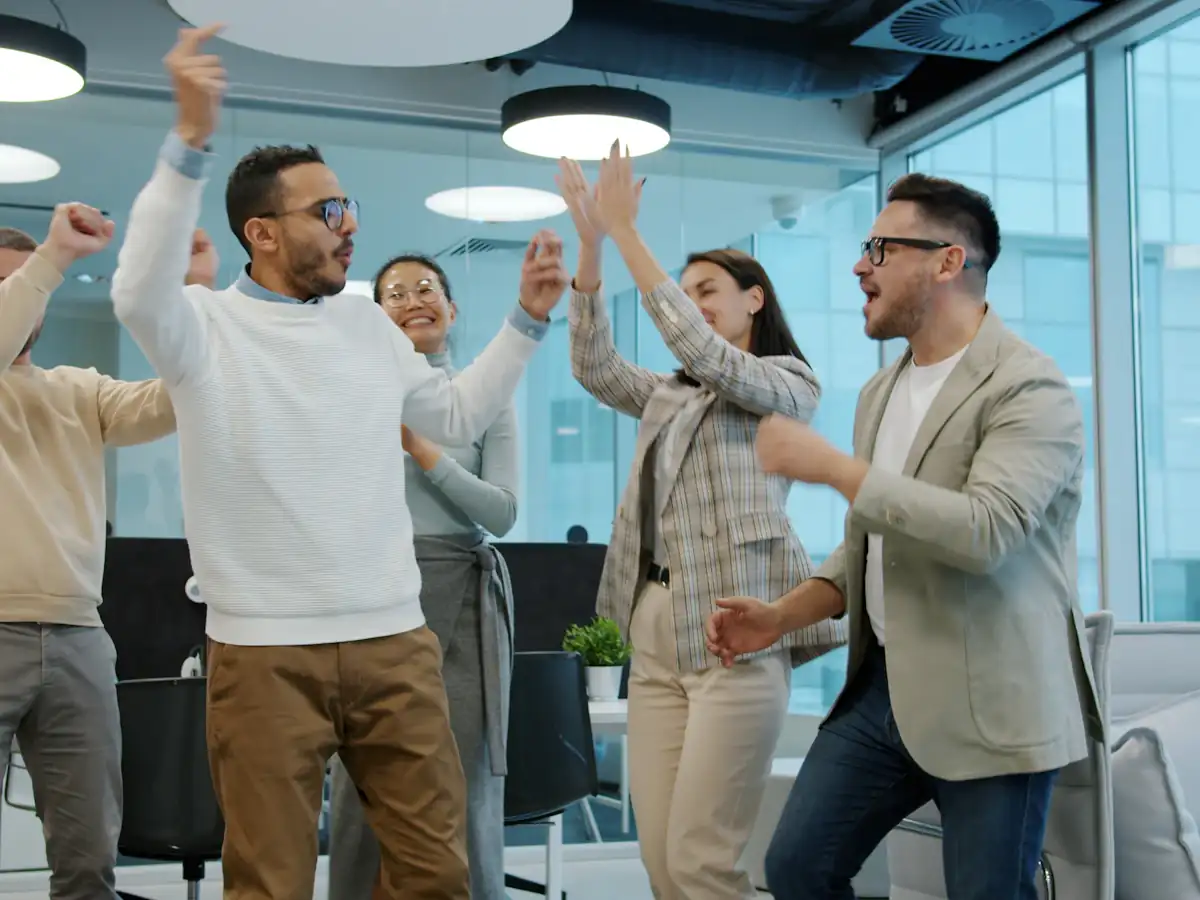 Diverse group of colleagues celebrating success in an office