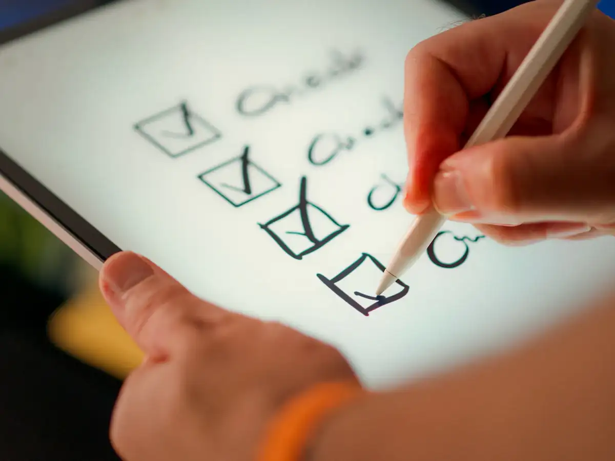 Hand marking off items on a checklist
