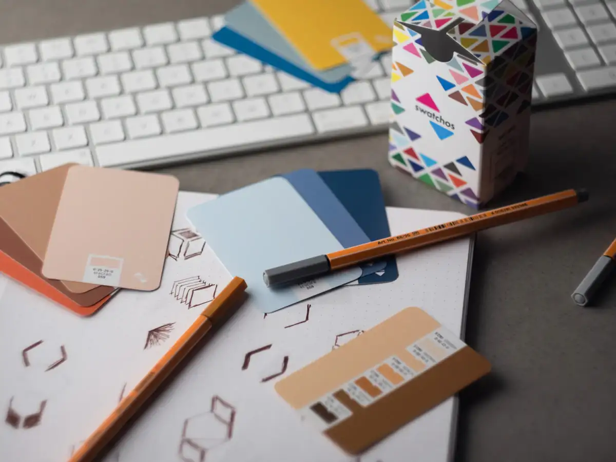 Desk with keyboard, pencils and brand colour samples